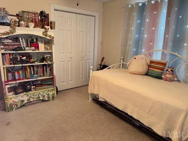 a bedroom with bed and a book shelf
