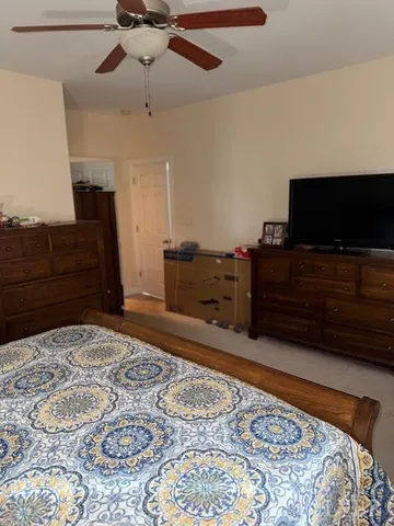 a bedroom with a bed and flat screen tv