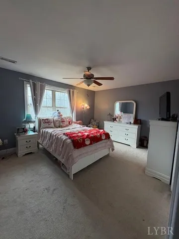 a bedroom with bed and window