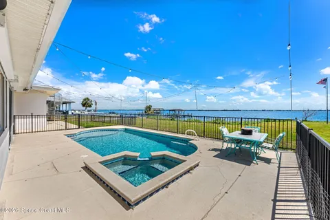 a view of swimming pool with outdoor seating and a patio