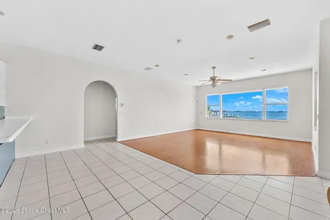 a view of room with window ceiling fan and hardwood floor