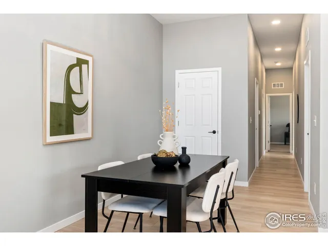 a view of a dining room with a table and chairs