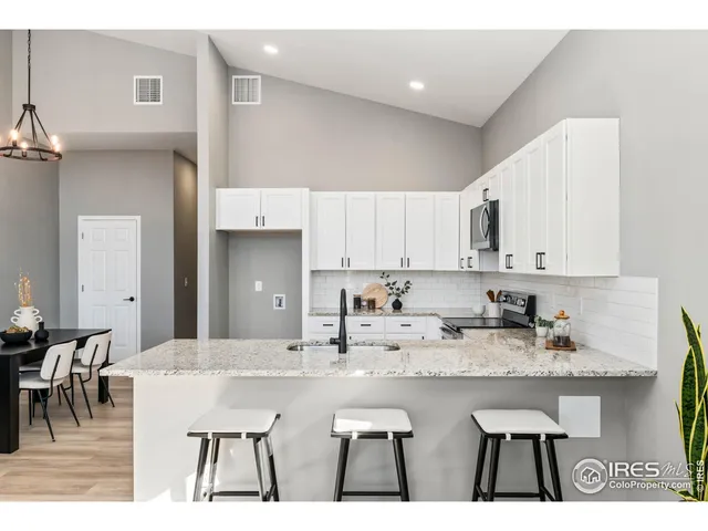 a kitchen with center island table and chairs
