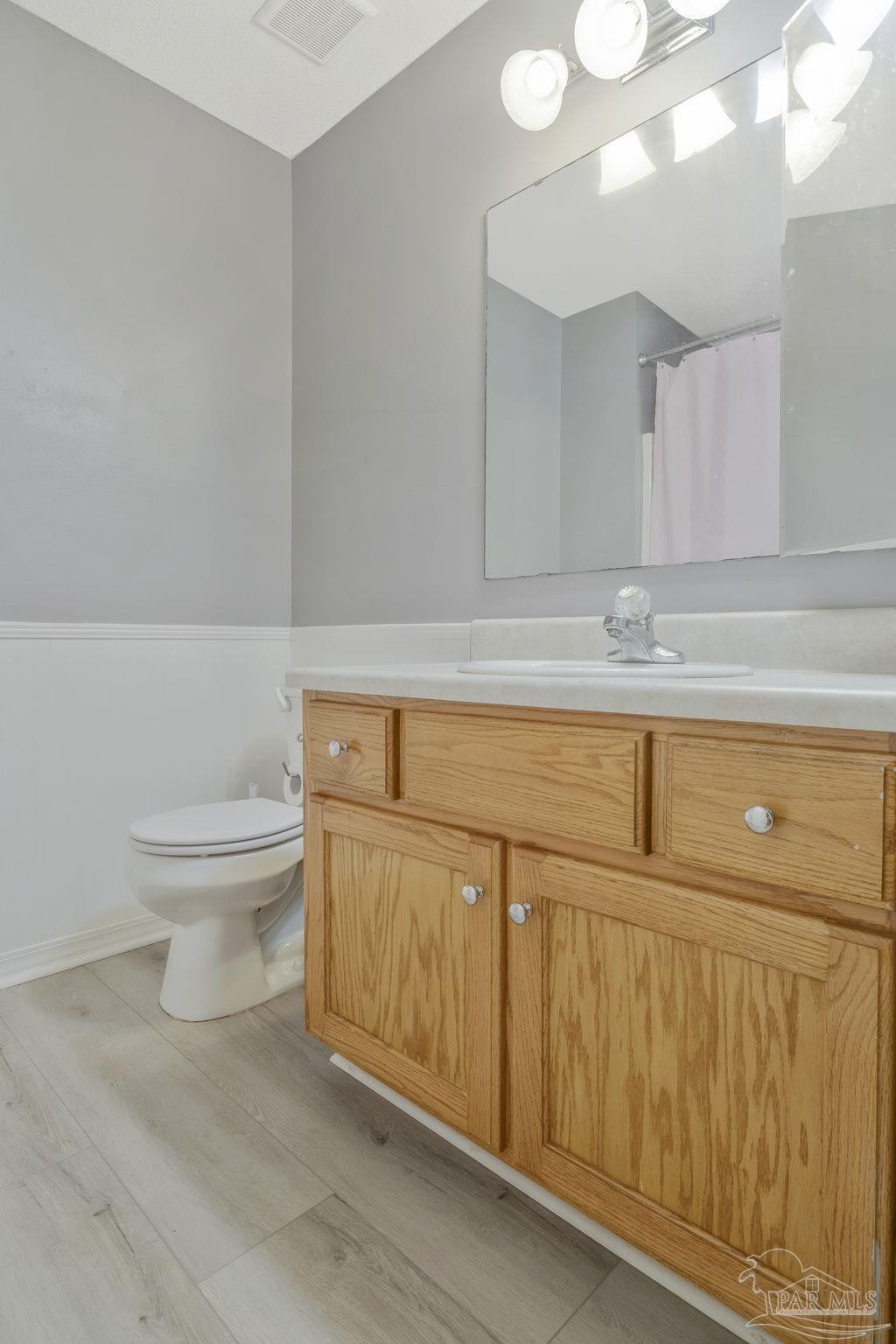 5539 Windrun Place Pace, FL 32571 - Photo 29 of 62 a bathroom with a sink a toilet and vanity