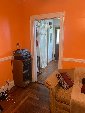 a living room with a couch and wooden floor