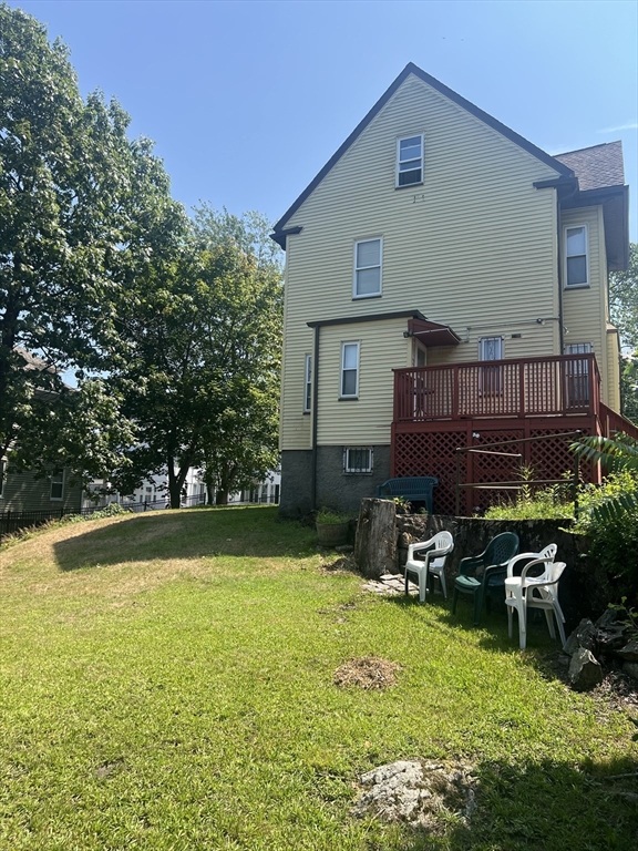 34 Ridlon Road Boston, MA 02136 - Photo 3 of 16 a view of a patio with table and chairs potted plants and large tree