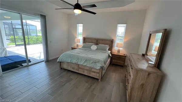 a bedroom with a bed wooden floor and window