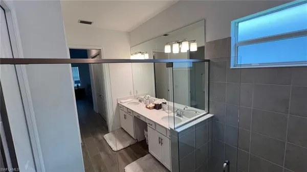 a bathroom with a sink vanity and a mirror