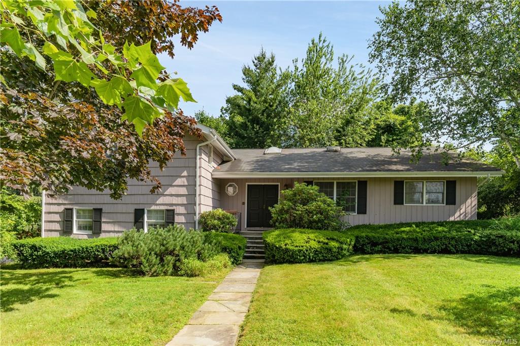 a front view of house with yard and green space