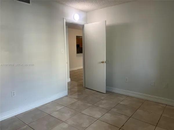 an empty room with entrance and shower