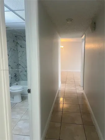 a bathroom with a granite countertop shower a toilet and a sink