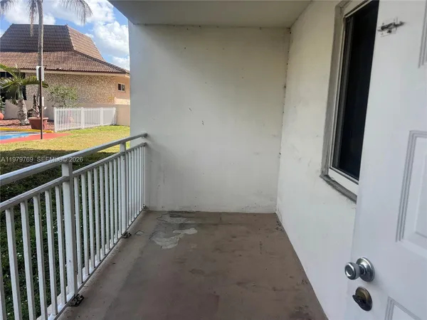 a view of a porch with wooden floor