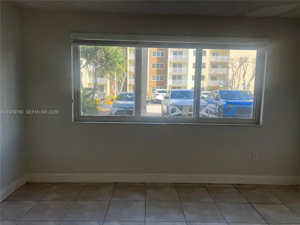 a view of a room that has a window and a kitchen space