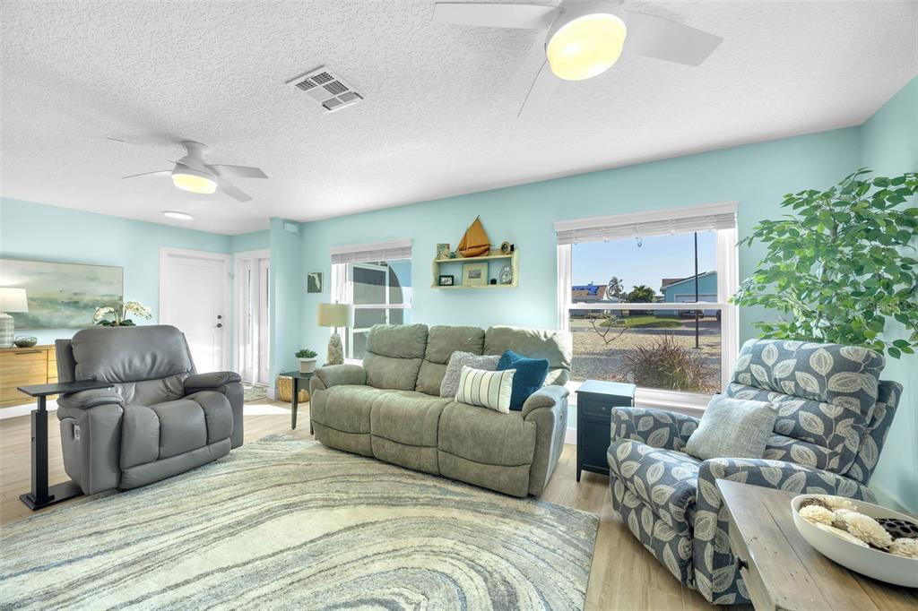 1015 Spindle Palm Way Apollo Beach, FL 33572 - Photo 30 of 78 a living room with furniture and a potted plant