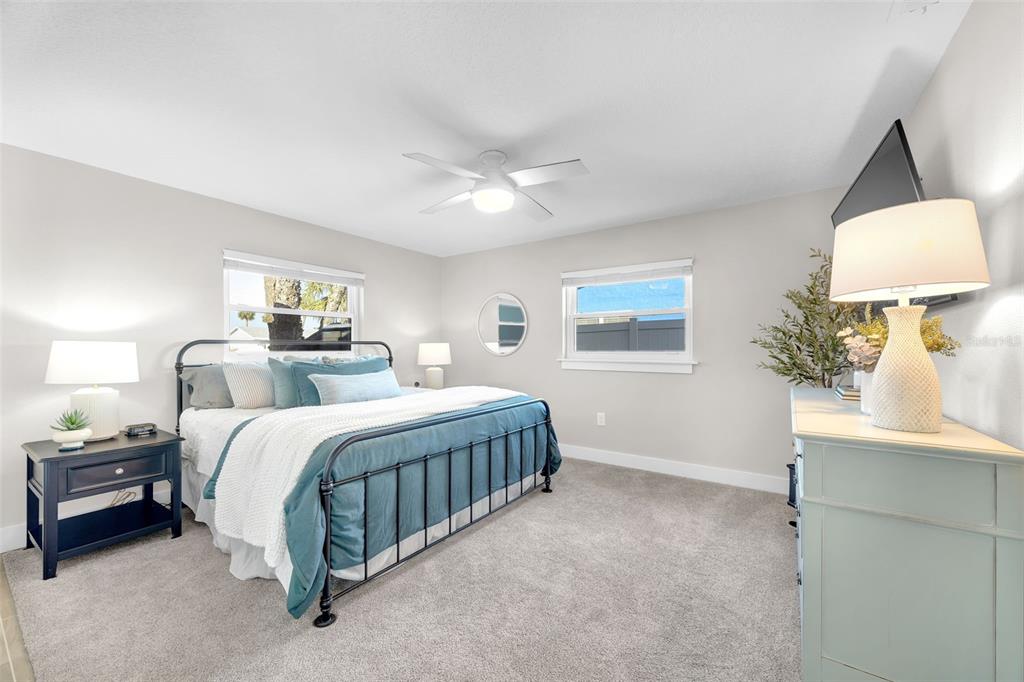 1015 Spindle Palm Way Apollo Beach, FL 33572 - Photo 39 of 78 a spacious bedroom with a bed a lamp on desk and a window