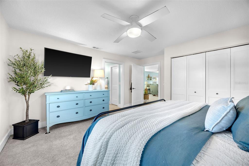 1015 Spindle Palm Way Apollo Beach, FL 33572 - Photo 42 of 78 a bedroom with a bed and a flat screen tv