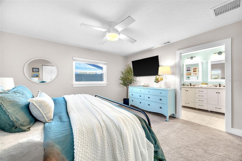 1015 Spindle Palm Way Apollo Beach, FL 33572 - Photo 44 of 78 a bedroom with a bed and a flat screen tv