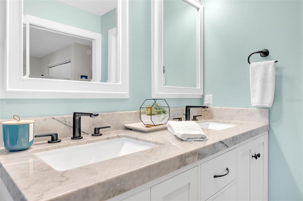 1015 Spindle Palm Way Apollo Beach, FL 33572 - Photo 46 of 78 a bathroom with sink and mirror