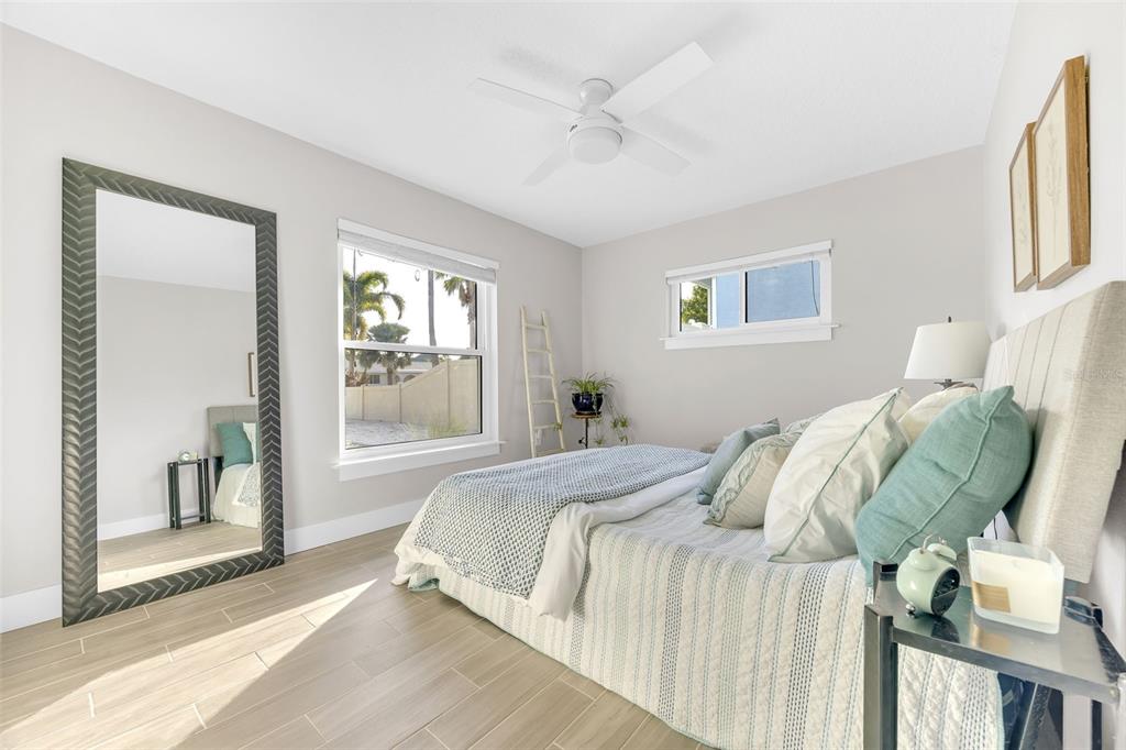 1015 Spindle Palm Way Apollo Beach, FL 33572 - Photo 50 of 78 a bed sitting in a bedroom next to a window