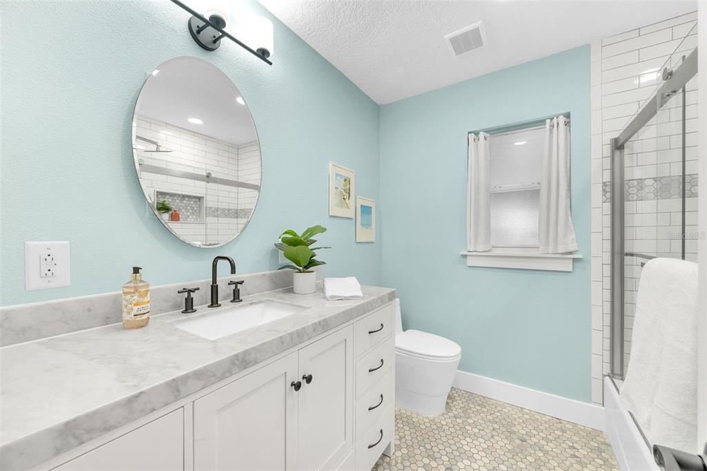 1015 Spindle Palm Way Apollo Beach, FL 33572 - Photo 51 of 78 a bathroom with a sink a toilet and a mirror