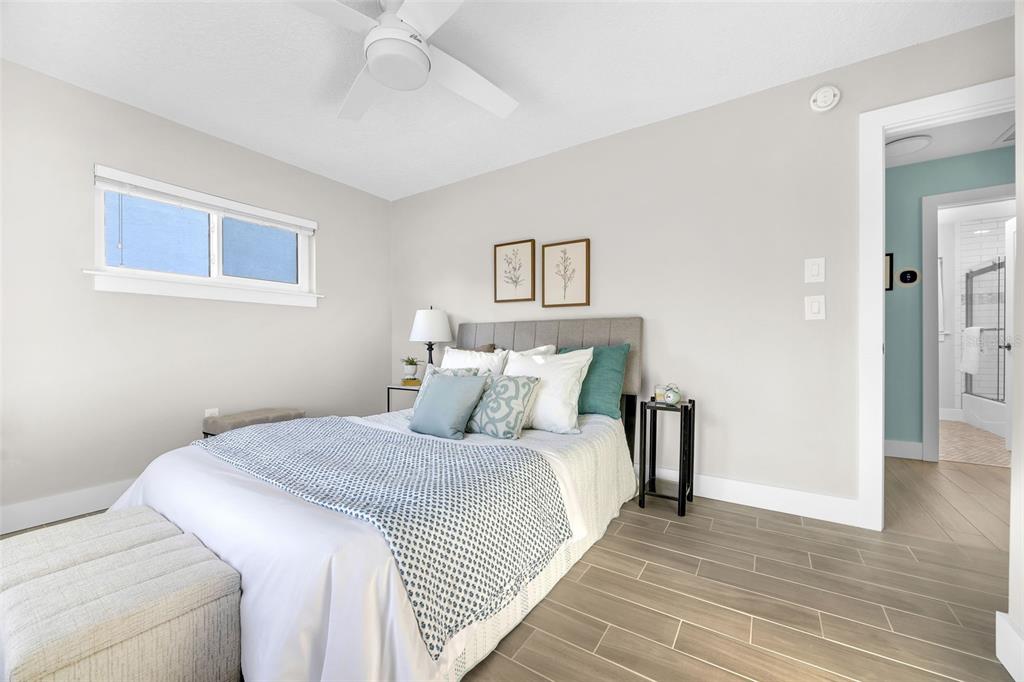 1015 Spindle Palm Way Apollo Beach, FL 33572 - Photo 53 of 78 a bedroom with a bed and a chandelier