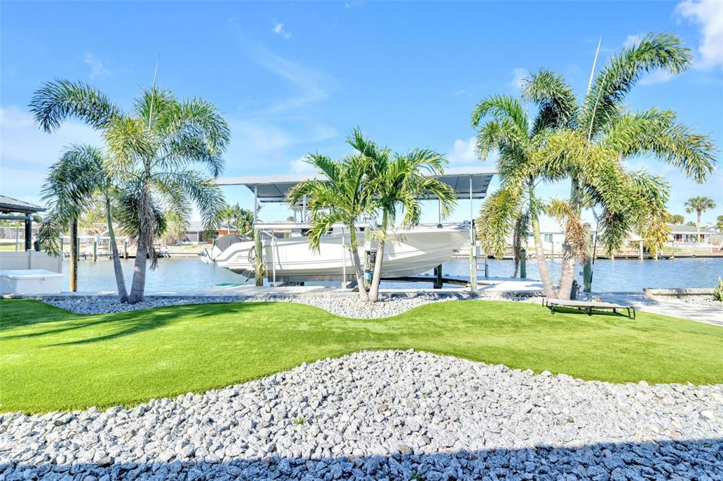 1015 Spindle Palm Way Apollo Beach, FL 33572 - Photo 58 of 78 a view of a swimming pool with a garden