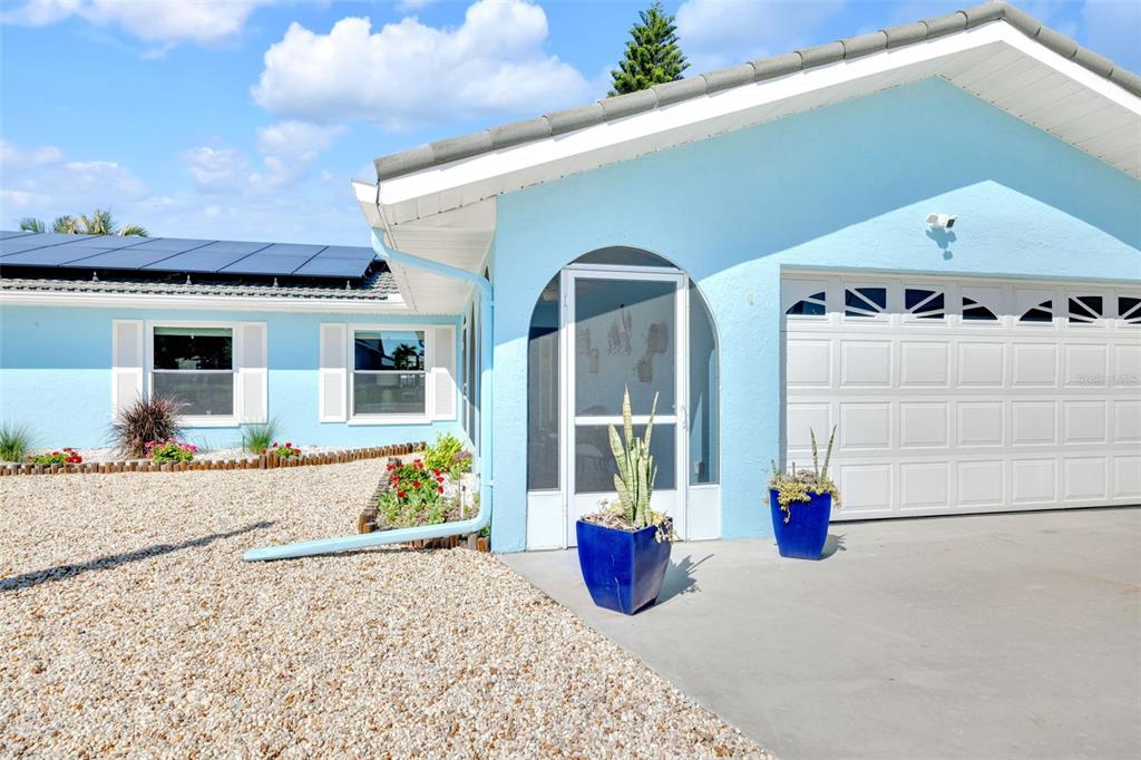 1015 Spindle Palm Way Apollo Beach, FL 33572 - Photo 10 of 78 a view of a house with a yard and potted plants