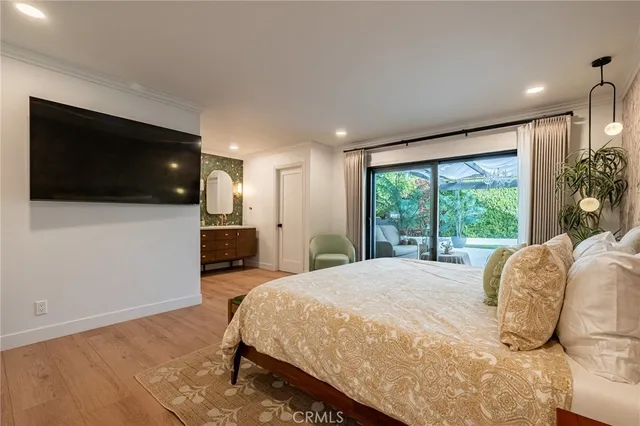 a spacious bedroom with a large bed and a flat screen tv