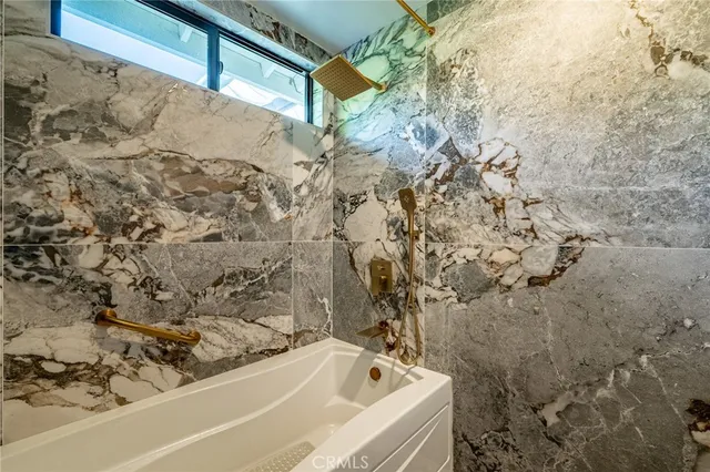 a bathroom with a bathtub and shower