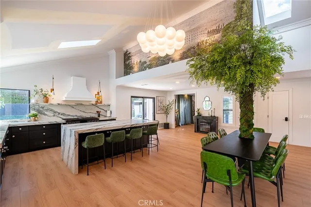 a living room with furniture a chandelier and a dining table