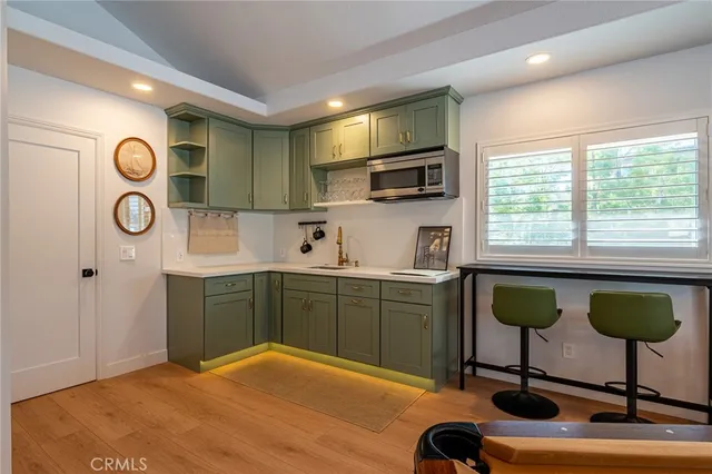 a kitchen with a sink cabinets and window