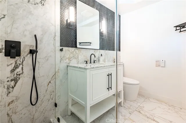 a bathroom with a sink toilet and mirror