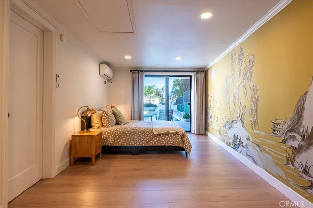 a spacious bedroom with a bed and wooden floor