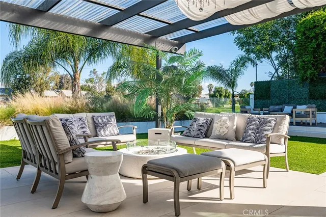 a view of a patio with a table and chairs