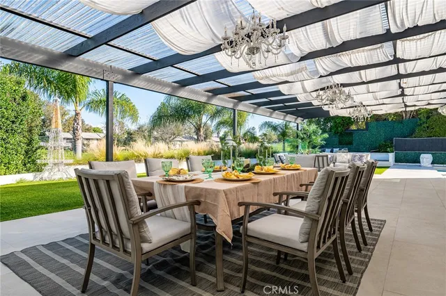 a view of an outdoor dining space with a table and chairs