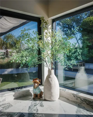 a white vase with flowers sitting on a table