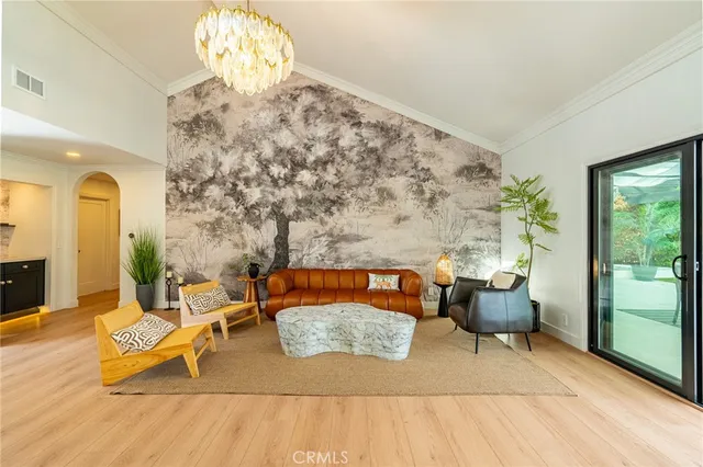 a living room with furniture a rug and a chandelier