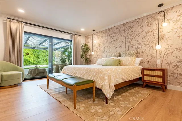 a bed sitting in a spacious bedroom next to a window