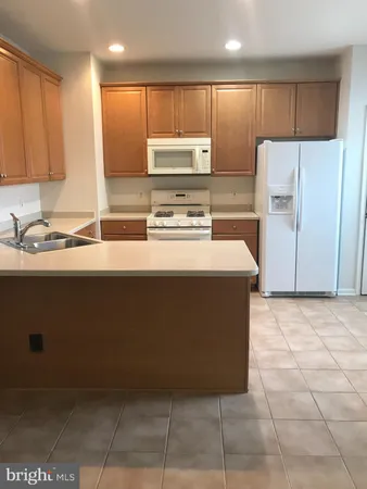 a kitchen with kitchen island cabinets and refrigerator