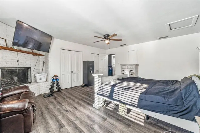 a bedroom with a bed and a fireplace