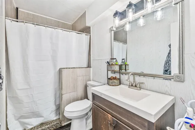 a bathroom with a sink toilet and shower