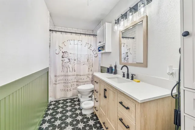 a bathroom with a sink toilet and shower