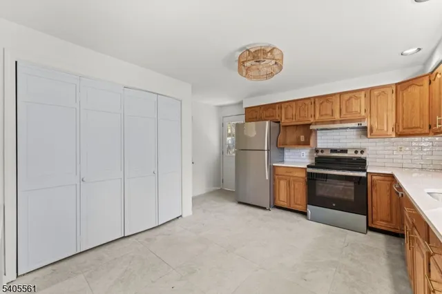 a kitchen with a refrigerator and a sink