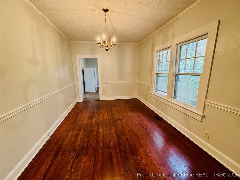 411 Carthage Road Lumberton, NC 28358 - Photo 13 of 25 a view of empty room with wooden floor and fan