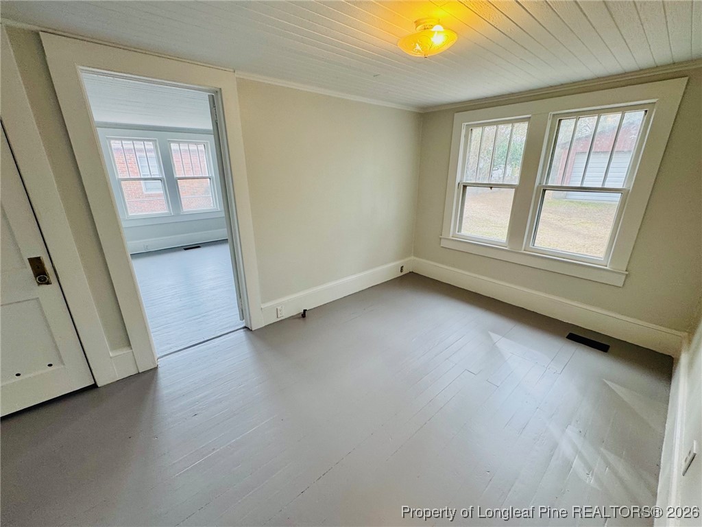 411 Carthage Road Lumberton, NC 28358 - Photo 18 of 25 an empty room with window and hardwood floor