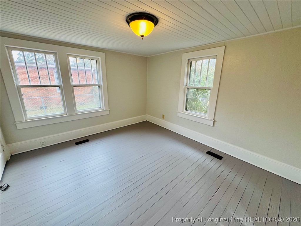 411 Carthage Road Lumberton, NC 28358 - Photo 20 of 25 a view of an empty room with a window and wooden floor