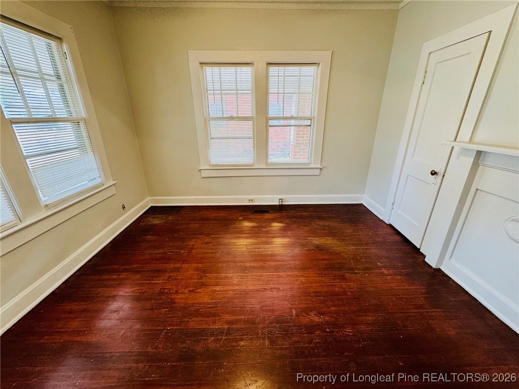 411 Carthage Road Lumberton, NC 28358 - Photo 7 of 25 a view of an empty room with wooden floor and a window