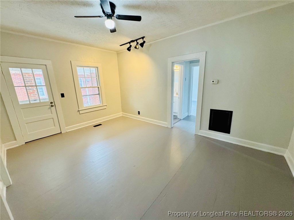 411 Carthage Road Lumberton, NC 28358 - Photo 8 of 25 an empty room with windows and cabinet