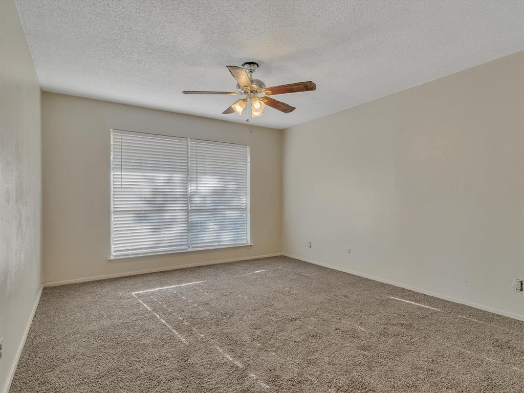 5053 Ridglea Lane, Unit 911 Fort Worth, TX 76116 - Photo 11 of 16 an empty room with windows and fan