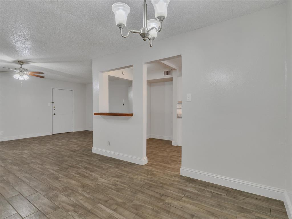 5053 Ridglea Lane, Unit 911 Fort Worth, TX 76116 - Photo 3 of 16 wooden floor in an empty room